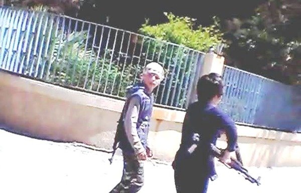 Two boys carry weapons in al-Raqa, an 'Islamic State of Iraq and the Levant' stronghold. [Photo courtesy of Syrian media activist 'Abu Sham al-Raqa']