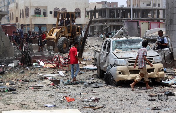 Yemenis inspect the site of a suicide car bombing claimed by the 'Islamic State of Iraq and the Levant' on August 29th at an army recruitment centre in Aden. [Saleh al-Obeidi/AFP]