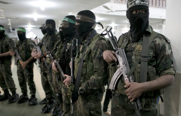 Members of the Ezzedine al-Qassam Brigades, the military wing of the Hamas, take part in the funeral of a fellow militant in March 2016. Hamas militants are co-operating with the Syrian regime under a group named al-Quds Brigades. [Said Khatib/AFP]