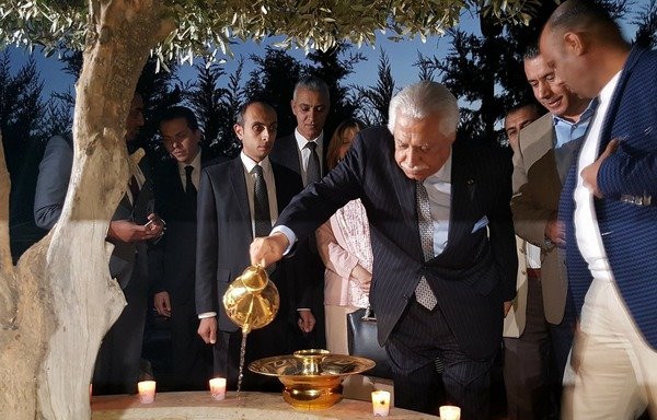 Amman mayor Aqel Biltaji waters an olive tree in remembrance of the victims of the 2005 Amman bombings. [Photo courtesy of Greater Amman Municipality]