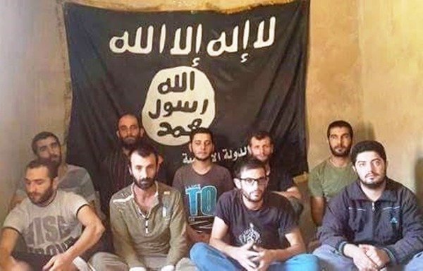 Nine Lebanese soldiers abducted by the 'Islamic State of Iraq and the Levant' appear in an August 2015 photo published by the group. [Photo courtesy of the father of soldier Mohammed Yousef]