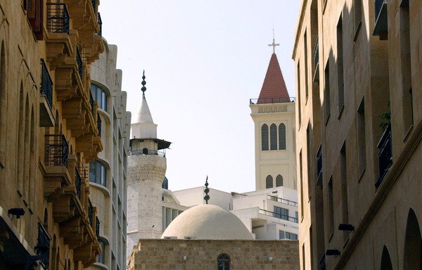 A minaret and a church bell tower appear side by side in downtown Beirut. Lebanese Muslim and Christian authorities have been working to highlight Lebanon’s role in the region as a model of religious co-existence, moderation and tolerance. [Patrick Baz/AFP]