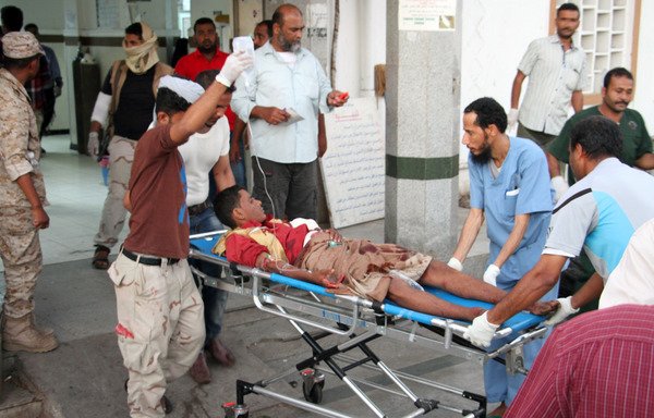 A wounded Yemeni man arrives at a hospital on December 10th after a deadly suicide attack on al-Sawlaban military camp in the port city of Aden. [Saleh al-Obeidi/AFP]