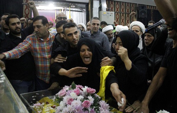 Supporters of Lebanon's Hizbullah attend the November 5th funeral of a fighter killed in combat in Syria alongside regime forces in a southern suburb of Beirut. [Stringer/AFP]