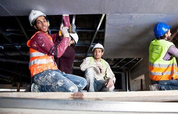 Syrian refugees work at a construction site in Amman. [Photo courtesy of the International Labour Organisation]
