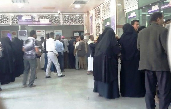 Yemeni government employees receive their salaries at al-Kuraimi Exchange Company in Sanaa. [Abu Bakr al-Yamani/Al-Mashareq]