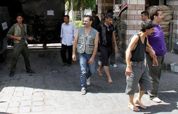 Emaciated men pictured inside Saydnaya prison in Syria. A recent report states groups of at least 50 inmates in the prison were taken out of their cells every week, beaten and then hanged in the middle of the night. [Photo from the archive of Bashir al-Bassam]