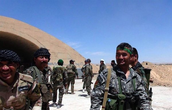 The Fatemiyoun Brigade, shown in December, is comprised of approximately 20,000 Afghan Shia mercenaries, according to media reports. Persian writing on the shelter's wall in Palmyra, Syria, says, "Herat boys of Fatemiyoun were here. Ya Zainab." [Tasnim News Agency]