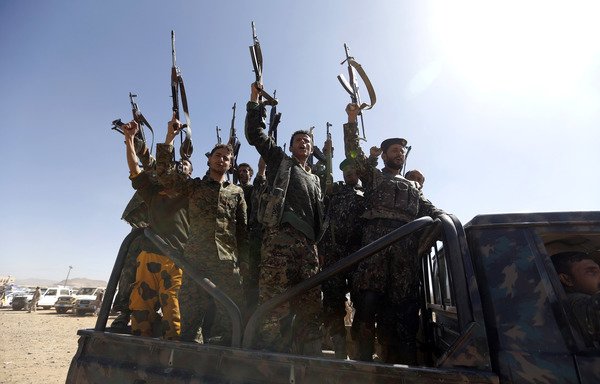 Newly recruited Houthi fighters ride in a military vehicle on January 3rd during a gathering in Sanaa to mobilise more fighters to battle Yemeni forces. [Mohammed Huwais/AFP]