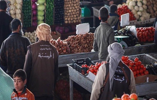 'Islamic State of Iraq and the Levant' al-hesba 'religious police' elements patrol Saray market in Mosul, where the group has been collecting levies from merchants. [Photo courtesy of the Ninawa Information Centre]