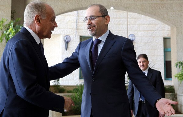 Jordanian Foreign Minister Ayman al-Safadi greets Arab League Secretary General Ahmed Aboul-Gheit in Amman on March 19th. Jordan is hosting the 28th Ordinary Session of the Arab League Council summit, which will open in the Dead Sea area on March 23rd. [Khalil Mazraawi/AFP]