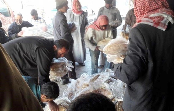 Bread is distributed free of charge to al-Bab residents after the Free Syrian Army reopened the city’s automated bread factory. [Photo from of al-Bab group Facebook page]