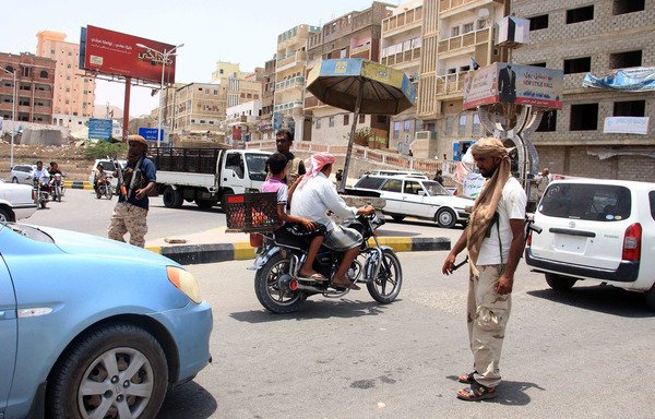 Yemeni forces inspect vehicles at a checkpoint in the Hadramaut provincial capital of al-Mukalla on July 19th, 2016. [Abduljabbar Bajubair/AFP]