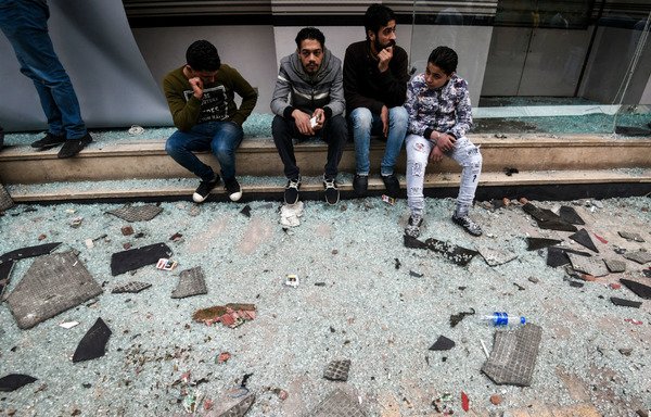 Egyptians gather by debris resulting from a blast which struck outside the Coptic Orthodox Patriarchate in Alexandria as worshippers attended Palm Sunday mass earlier on April 9, 2017. The 'Islamic State of Iraq and Syria' claimed responsibility for the attack. [Mohamed el-Shahed/AFP]