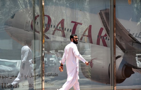 A man walks past the Qatar Airways branch in the Saudi capital Riyadh on June 5th, after it suspended all flights to Saudi Arabia following a severing of relations between major Gulf states and Qatar. Arab nations cut ties with Qatar, accusing it of supporting extremism, in the biggest diplomatic crisis to hit the region in years. [Faye Nureldine/AFP]