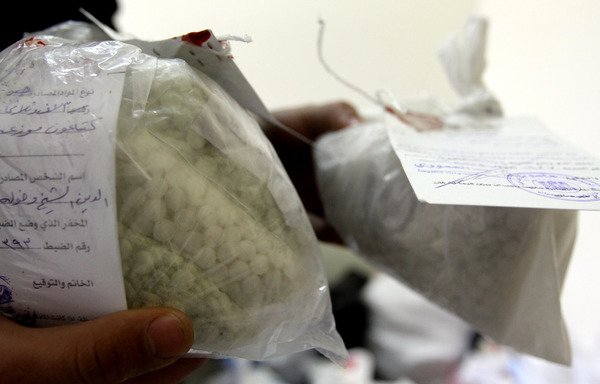 Syrian police show seized drugs and Captagon pills at the Drug Enforcement Administration in Damascus on January 4th, 2016. This illegal drug has flourished in the chaos of Syria's war. [Louai Beshara/AFP]