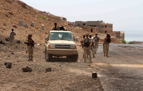 Yemeni soldiers stand guard at the scene of a car bomb attack at an army checkpoint outside Hajr in Hadramaut province on July 18th, 2016. Hadramaut elite forces on June 12th thwarted an al-Qaeda attack on a military camp in the province.  [Abduljabbar Bajubair/AFP]