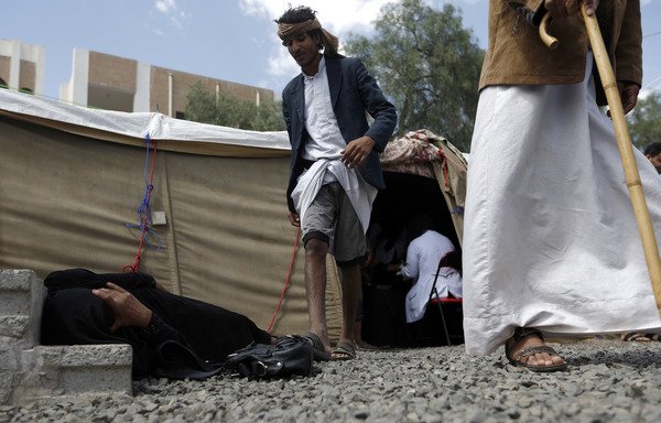 A Yemeni woman suspected of being infected with cholera lies on the ground at al-Sabaeen Hospital in Sanaa on June 13th. [Mohammed Huwais/AFP]
