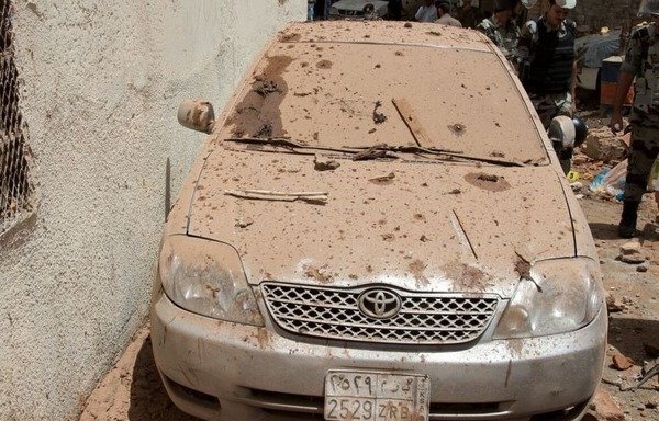 A car in Mecca's Ajyad al-Masafi district near the Grand Mosque is covered with debris after an attacker blew himself up in a nearby building, which partially collapsed. [Photo courtesy of Saudi Press Agency]
