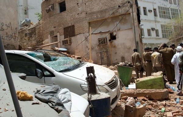 Saudis inspect the destruction caused after a suicide bomber blew himself up in a four-story building near Mecca's Grand Mosque. [Photo courtesy of Saudi Press Agency]