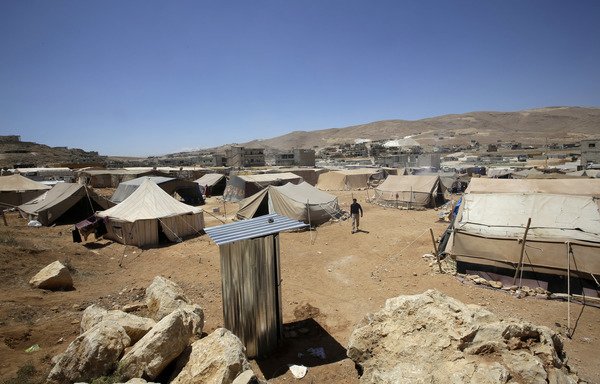 This file photo taken on June 14th, 2013 shows tents at a Arsal refugee camp. Five militants blew themselves up during raids on two area refugee camps on June 30th, killing a child and wounding seven soldiers. [Joseph Eid/AFP]