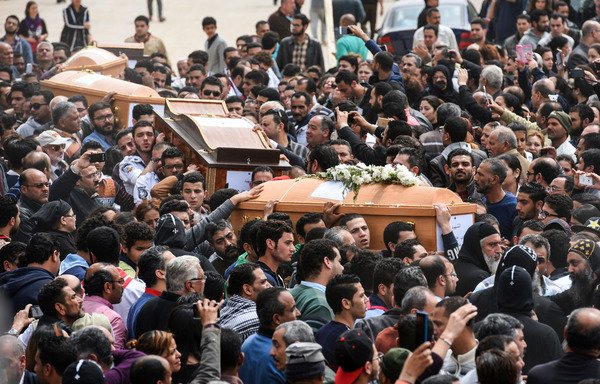 Mourners carry the coffins of the victims of the blast at St. Mark's church in Alexandria during a funeral procession at the Monastery of Mar Mina in the nearby city of Borg el-Arab on April 10th. [Mohamed el-Shahed/AFP]