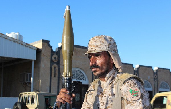 A fighter loyal to Yemen's President Abed Rabbu Mansour Hadi holds a Rocket Propelled Grenade (RPG) as he guards a position in Shabwa, east of the Red Sea port of Aden, on December 21st, 2015. [Saleh al-Obeidi/AFP]