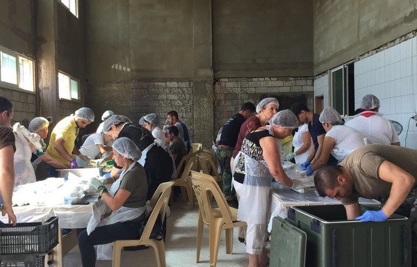 Lebanese prepare meals for soldiers fighting on the front lines in the outlying areas of Ras Baalbek and al-Qaa. [Photo courtesy of Sister Agnes Laham]