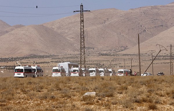 Vehicles carrying 'Islamic State of Iraq and Syria' fighters are seen in the Qara area of Syria's Qalamoun region on August 28th as they leave for eastern Syria. [Louai Beshara/AFP]