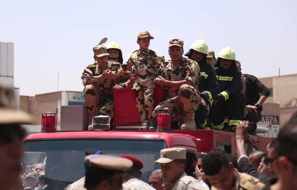 Egyptian soldiers and a boy in a military outfit on July 8th stand with the coffins of soldiers killed in Sinai a day earlier in an 'Islamic State of Iraq and Syria' attack. The army struck ISIS targets in Sinai on Tuesday (September 12th) following a deadly Monday attack on police on the peninsula. [Mahmoud Bakkar/AFP]