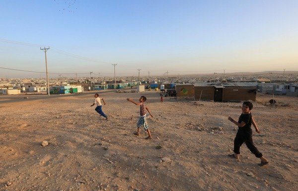 Syrian refugee children play in Jordan's Zaatari camp where international organisations have just opened an employment centre to help refugees find jobs. [Photo courtesy of Mohammad Abu Ghosh]
