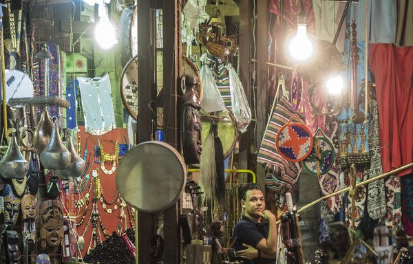 An Egyptian shopkeeper waits for customers outside his shop in a Luxor market on September 10th. [Khaled Desouki/AFP]