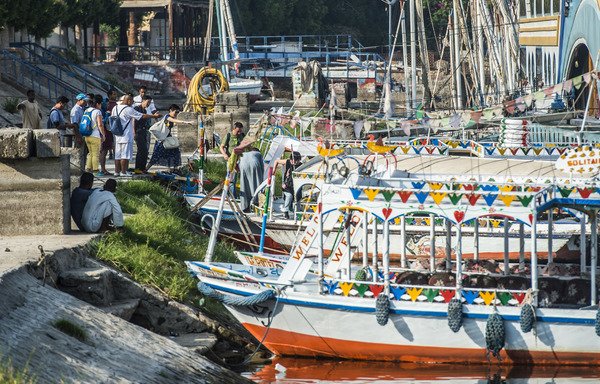 Tourists board a boat in the southern Egyptian town of Luxor on September 10th. [Khaled Desouki/AFP]