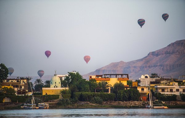 Hot air balloons are seen during a ride over the ancient city of Luxor on September 10th. [Khaled Desouki/AFP]