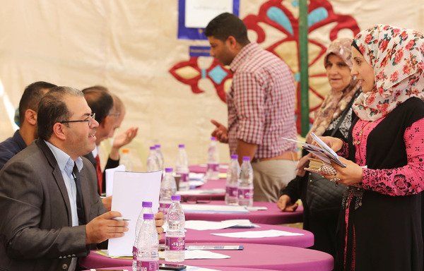 نساء سوريات يسجلن أسماءهن خلال معرض للوظائف في مركز التشغيل بمخيم الزعتري للاجئين السوريين في 4 تشرين الأول/أكتوبر. [خليل مزرعاوي/أ ف ب]