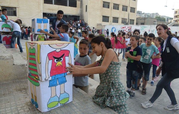 أطفال سوريون يشاركون في نشاطات ترفيهية من ضمن مشروع موزاييك التابع لمنظمة اليونيسف. ويهدف البرنامج إلى إعادة دمج الأطفال في محيطهم وبناء قدراتهم وابعاد شبح الخوف والاعمال العدائية عنهم. [حقوق الصورة لمركز سلحب التابع لليونيسف]