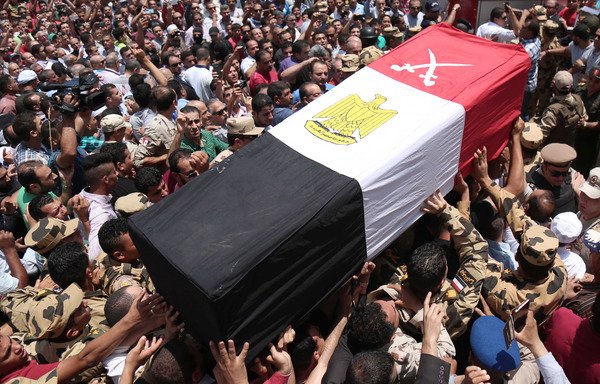 Egyptians carry the coffin of a soldier who was killed in the restive Sinai Peninsula in an attack by the 'Islamic State of Iraq and Syria', during a funeral ceremony north of Cairo, on July 8th. [Mahmoud Bakkar/AFP]