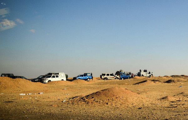 A picture taken on Saturday (October 21st) shows vehicles and armoured personnel carriers belonging to the Egyptian forces parked on the road leading to the Bahariya oasis in Egypt's Western desert. [Mohamed el-Shahed/AFP]