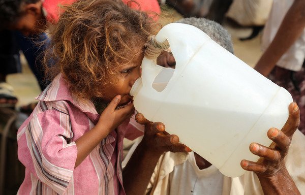 A Yemeni girl drinks water collected from a well in an impoverished village on the outskirts of al-Hodeidah on July 23rd. The region has been facing acute water shortages due to drought conditions. [Abdo Hyder/AFP]