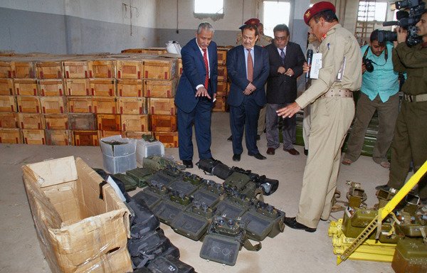In this file photo from February 8th, 2013, a Yemeni military official in Aden shows binoculars that were found among weapons and military equipment from Iran seized from a vessel in Yemen's territorial waters on January 23rd. [AFP PHOTO/STR]