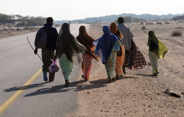 Somali refugees walk near the Yemeni town of Ahwar in this file photo from October 14th, 2008, one day after they reached the Yemeni coast aboard smugglers' boats. Efforts are ongoing to block human traffickers, some of whom bring illegal arms into Yemen. [Khaled Fazaa/AFP]