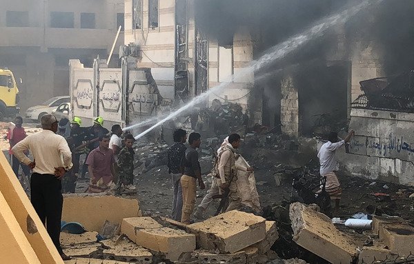Yemeni firefighters douse flames following a November 14th  explosion near a security post in the southern port city of Aden claimed by the 'Islamic State of Iraq and Syria'. [Nabil Hassan/AFP]
