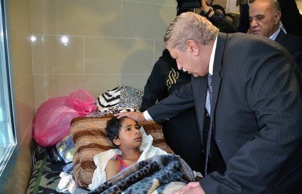 Yassin Taher (R), Ismailia governor, visits victims of the attack that targeted the Rawda mosque near North Sinai provincial capital of al-Arish, on November 25th, 2017, at a hospital in the eastern port city of Ismailia. Armed attackers killed 305 worshippers in a bomb and gun assault on the packed mosque in North Sinai, in the country's deadliest attack in recent memory. [STR/AFP]