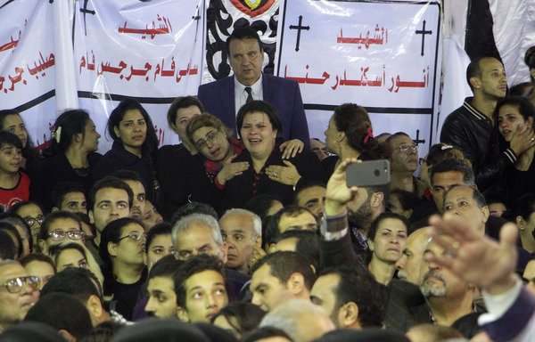 Egyptian Christians gather for the late night funeral of the victims of a blast which killed worshippers attending Palm Sunday mass at the St. George's Coptic Orthodox Church in the Nile Delta City of Tanta, north of Cairo, on April 9th. [Stringer/AFP]