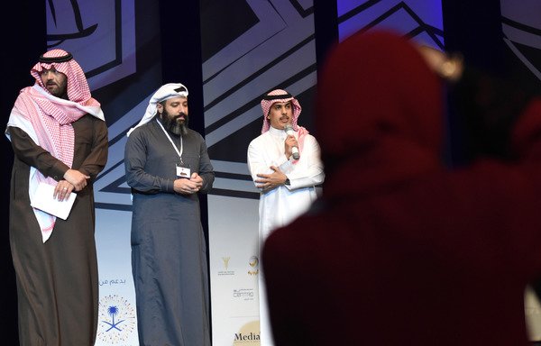 Saudi members of the Stand-up Comedy Festival, Yusuf Aljarrah, Faisal Alamer and Yasser Baker stand on stage during the amateur comedy festival at the Riyadh's King Fahd Cultural Centre on November 29th. [Fayez Nureldine/AFP]