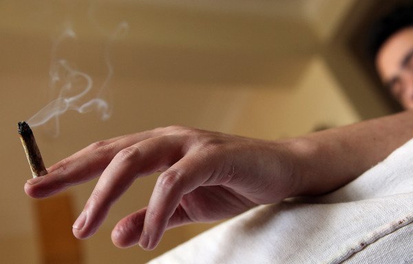 A man smokes a hashish joint at his home in Cairo in this file photo from April 4th, 2010. According to the Egyptian army, 'Islamic State of Iraq and Syria' affiliate Wilayat Sinai has been engaged in the drug trade to raise money for its operations. [Victoria Hazou/AFP]