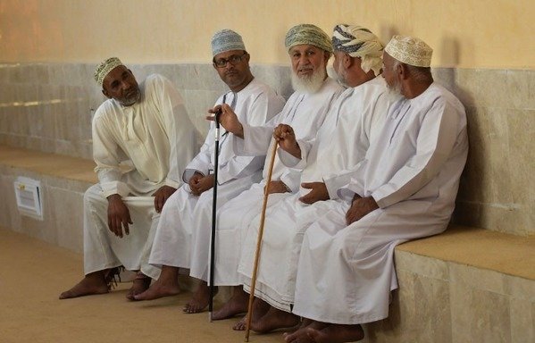Omani men chat in the meeting room of the traditional local council known as the "sabla" in the small village of Ghala, near Muscat, on October 27th, 2017. The men in Ghala village gather each Friday for the "Sabla", a traditional council where problems large and small are mediated without interference from the state. [Giuseppe Cacace/AFP]