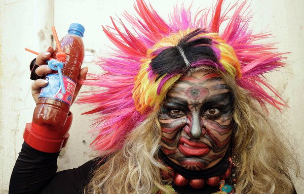 A Lebanese woman takes part in the Zambo carnival held in Tripoli on February 18th. The festival, of unknown origin, draws revelers from many different backgrounds. [Ibrahim Chalhoub/AFP]