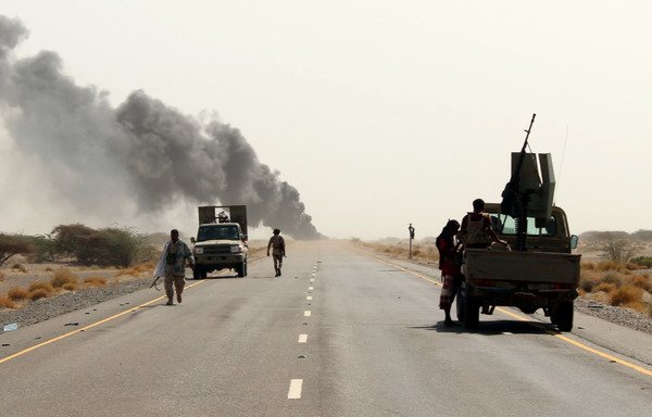 Yemeni forces are seen with their vehicles on the road leading to the town of Khokha which was retaken from the Houthis on December 7th, 2017. [Saleh al-Obeidi/AFP]