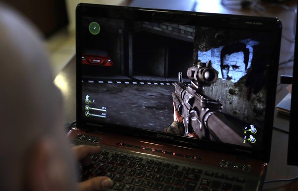 A Lebanese man plays Hizbullah's 'Holy Defence' video game, which simulates the Syrian war, in a southern suburb of Beirut on February 27th. Critics have strongly condemned the game. [Joseph Eid/AFP]